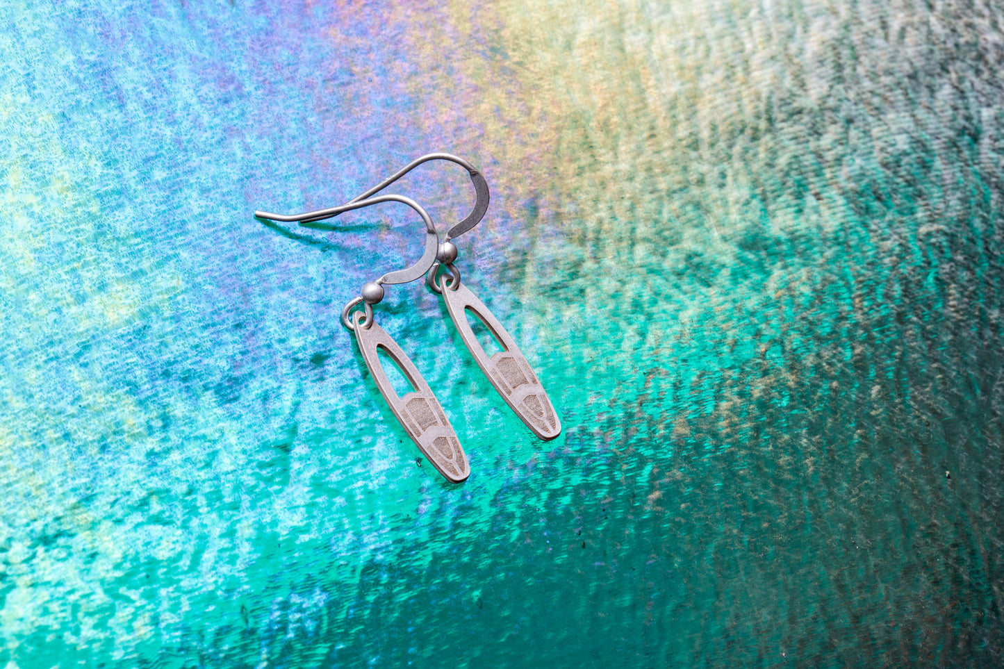 a pair of stirling silver surfboard earrings with grip mats