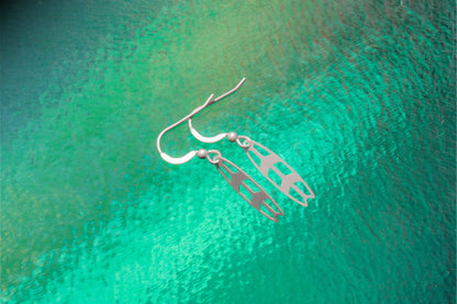 a pair of sterling sliver earrings inspired by surfing 